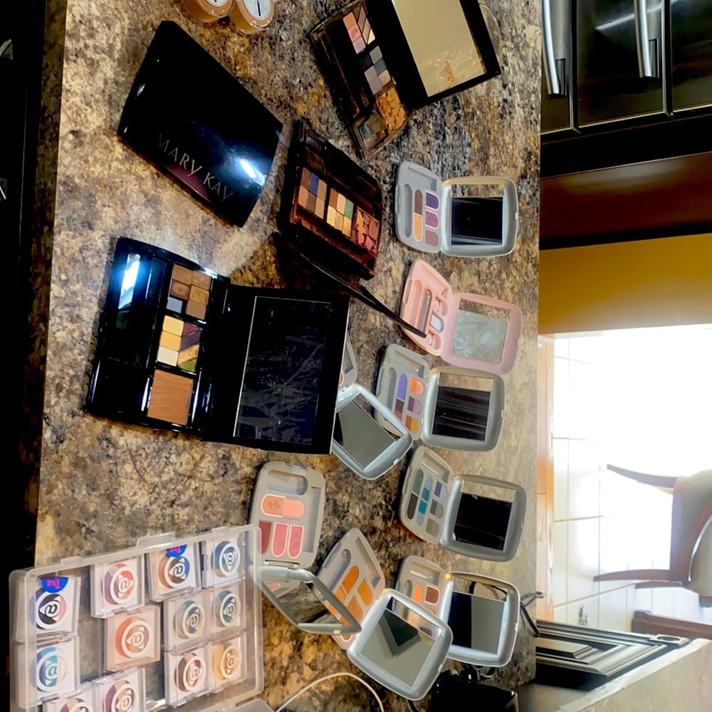 Multiple Mary Kay products and cases included.